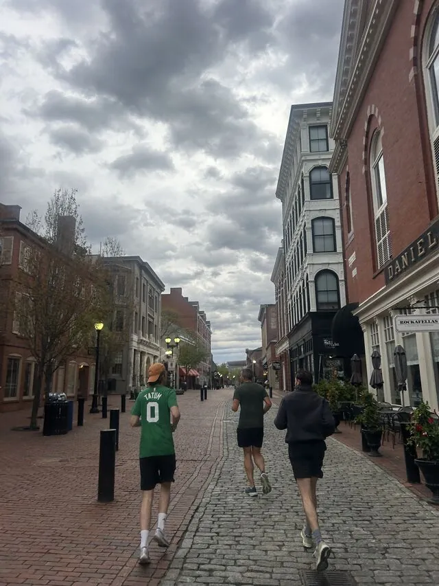 Colleagues out running on a cobbled Salem street at dusk